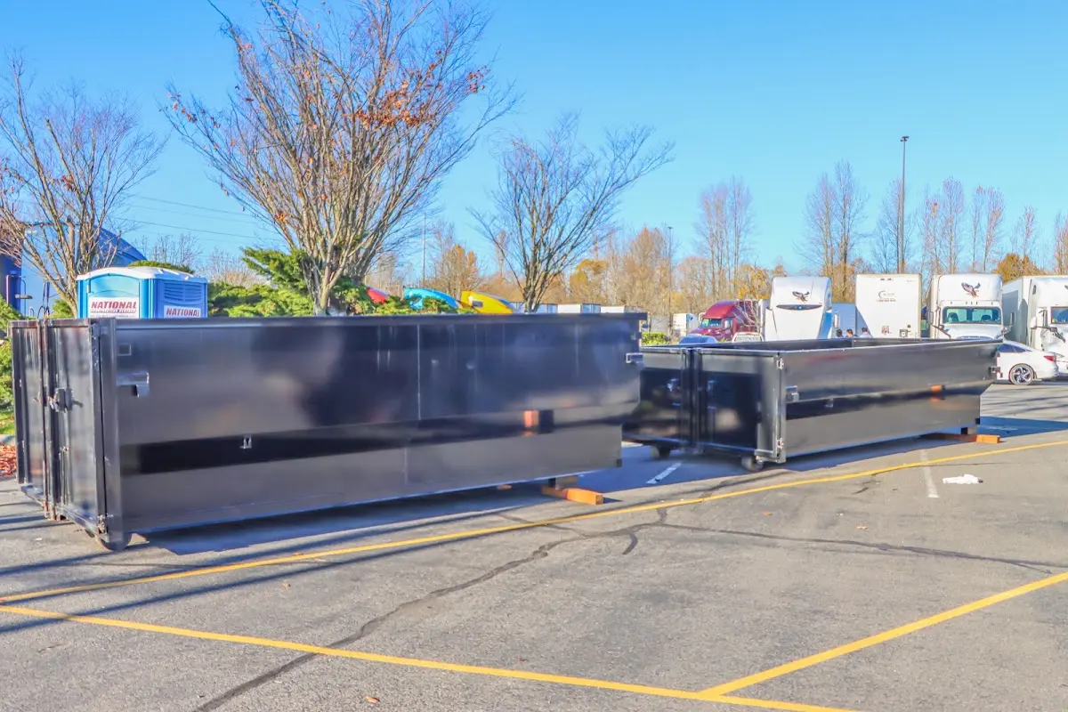 Professional dumpster rental service with roll-off container on residential driveway in Edina